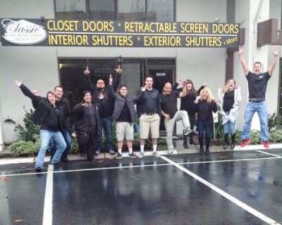 Group photo in front of store jumping for joy