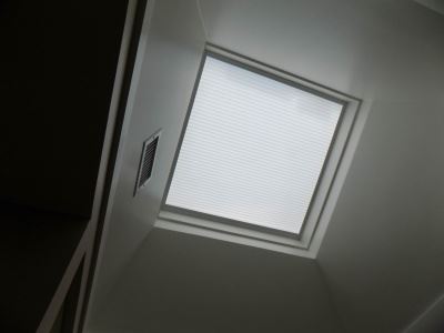 Motorized Honeycomb Skylight Shade on a ceiling window