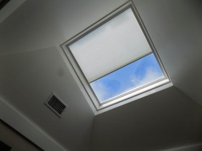 Motorized Honeycomb Skylight Shade on a ceiling window