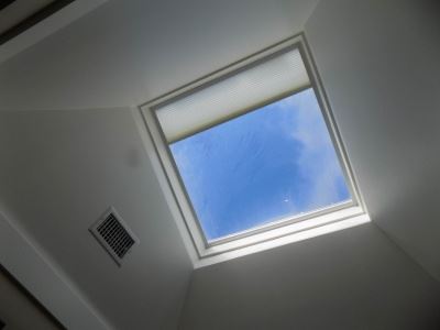 Motorized Honeycomb Skylight Shade on a ceiling window