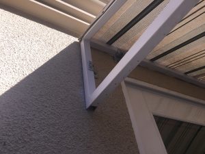 bad paint job on sloped trellis awning cover