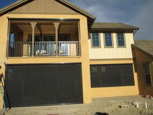 Motorized Power Screens with black solar screen and brown aluminum housing