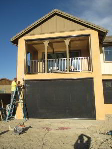 Motorized Power Screens with black solar screen and brown aluminum housing