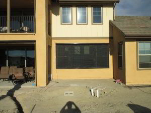 Motorized Power Screens with black solar screen and brown aluminum housing